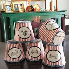 four lampshades with animals on them sitting on a table