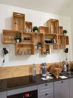 a kitchen with wooden shelves above the sink