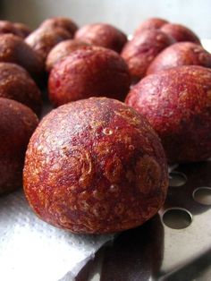 there are several balls of food on the counter top, one is red and the other is brown