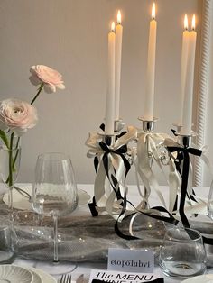 the table is set with white flowers and candles