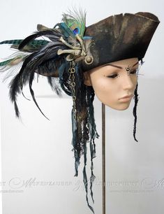 + + + Pirate Hat + + + The pirate hat is made of aged premium woolfelt. It is adorned with bones, various feathers, chains, buttons and textile materials. The hat is available in sizes between: 54 & 64 Size -> Circumference of your head in cm + + +     + + + Information about the feathers: Feathers are not colourfast and if they get wet it is possible that they change colour a little. Please note this if you come into heavy rain. + + +     + + + I create these hats in the studio "Maskenzauber & Authentic Pirate Hat, Pirate Hat With Feathers, Big Pirate Hat, Brown Pirate Hat, Diy Captain Hook Hat, Pirate Hats Diy, Pirate Hat Women, Decorated Pirate Hat, Pirate Hat Design