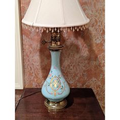 a blue lamp sitting on top of a wooden table