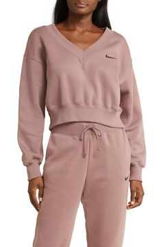 Minimally branded with an embroidered Swoosh, this classic sweatshirt is reimagined with a V-neck and cropped length. V-neck Ribbed cuffs and hem 80% cotton, 20% polyester Machine wash, tumble dry Imported Jordan Air Max, Nike Sportswear Phoenix Fleece, Sport Nike, Wide Leg Sweatpants, Club Sweatshirts, Oversized Crewneck, Loungewear Sets, Nike Store, Womens Fleece