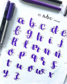 the upper and lower letters are drawn in purple ink on a sheet of white paper