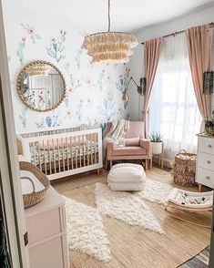 a baby's room decorated in pastel colors and floral wallpaper, including a crib