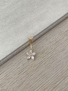 a diamond flower pendant on a wooden floor