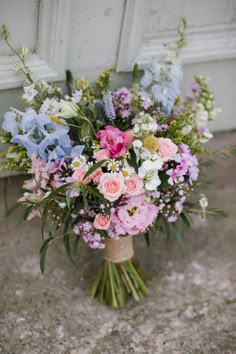 a bouquet of flowers sitting in front of a door