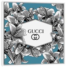 the gucci logo surrounded by flowers and leaves on a blue background canvas wall art print