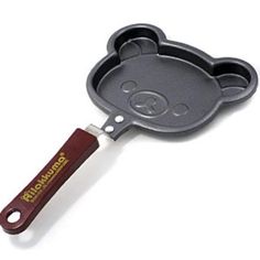 a pan shaped like a bear holding a spatula