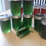 green peppers and jars of pickles on a table