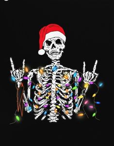 a skeleton wearing a santa hat and holding two fingers up in front of christmas lights