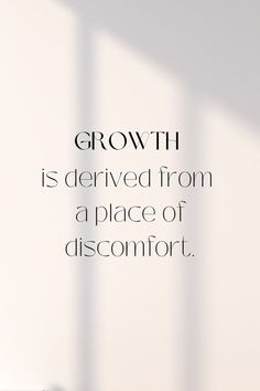 a white wall with the words growth is delivered from a place of discomfort