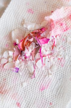 shredded pink and white paper sitting on top of a table