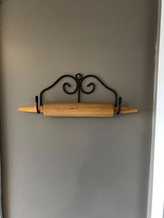 an iron and wood shelf on the wall