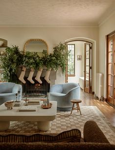 a living room filled with furniture and a fire place in the middle of a room