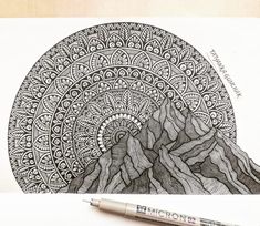 a drawing of mountains with an intricate design