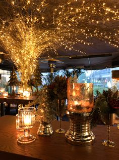 a table topped with candles and cakes covered in lights