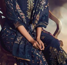 COLOR : Navy Blue FABRIC : Top - Pure Dola Silk Jacquard, Bottom - Soft Crepe , Dupatta - Chinon Silk WORK : Woven Zari Work, Zari Embroidery, Digital Print, Hand Work, Beads, Stones, Sequins, Lace Border OCCASION : Wedding, Reception, Engagement, Party Wear READY-TO-WEAR : NoSTITCHING : Available as semi-stitched fabric, can be stitched using standard size option (+$20). Note: There might be a slight color variation due to lighting and flash used during photoshoot. The bright shade seen is the Wedding Gharara, Gharara Suits, Zari Embroidery, Navy Blue Fabric, Zari Work, Silk Wedding, Lace Border, Hand Work, Embroidered Silk