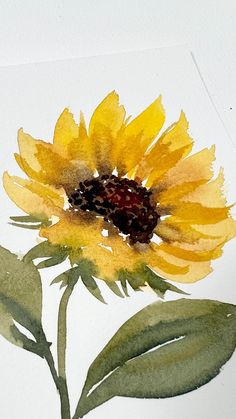 a watercolor painting of a sunflower with green leaves on the bottom and yellow petals on the top