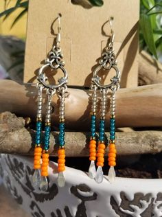 Want to put a little color in your outfit? These earrings will do just that.  Vibrant Orange seed beads on the bottom, teal above and gray above those. Finished with sterling silver hooks. Dangle Earrings With Silver Beads For Festivals, Festival Dangle Earrings With Silver Beads, Silver Beaded Dangle Earrings For Festivals, Silver Teardrop Beaded Earrings With Colorful Beads, Bohemian Silver Beaded Earrings With Tiny Beads, Handmade Silver Beaded Earrings For Festival, Bohemian Silver Beaded Earrings, Nickel-free Orange Beaded Dangle Earrings, Turquoise Silver Beaded Dangle Earrings