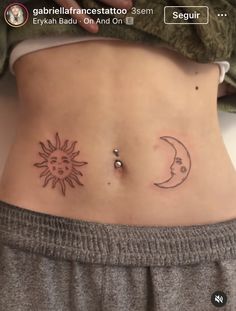 a woman's stomach with two sun and moon tattoos on the side of her belly