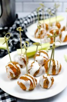 some food is sitting on a white plate with toothpicks in the shape of apples