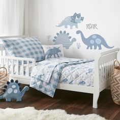 a child's bedroom with dinosaur decals on the wall