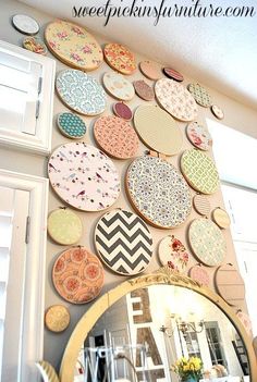 the wall is covered with many different types of embroiderys and circular designs on it