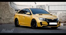 a yellow car parked in front of a building