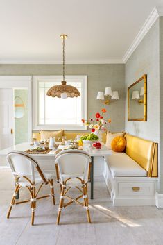 a dining room table with chairs and a bench