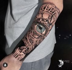 a man with a clock and eye tattoo on his arm