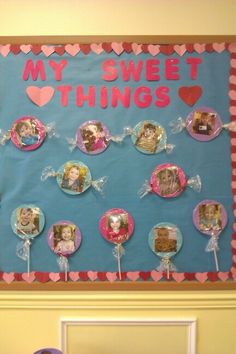 a bulletin board with many pictures on it and some lollipops in the shape of hearts