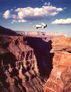 an airplane is flying over a canyon in the desert