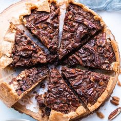 a pecan pie is cut into slices on a plate