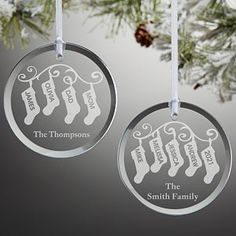 two ornaments hanging from a christmas tree with the names of three families on them,