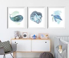 three framed art prints in a baby's room