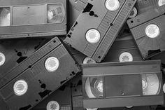 black and white photograph of old video tapes