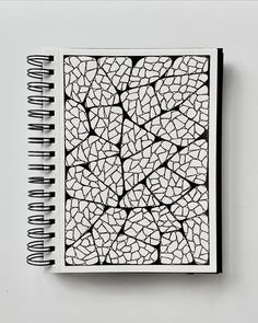 a notebook with black and white designs on it