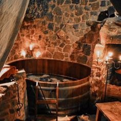 an old fashioned hot tub in a stone walled room