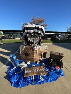 a wooden sign sitting on top of a blue tarp next to a pile of junk