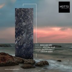 a tall pillar sitting on top of a sandy beach next to the ocean under a cloudy sky