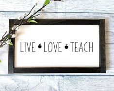 a black and white sign that says live love teach with an apple in the middle