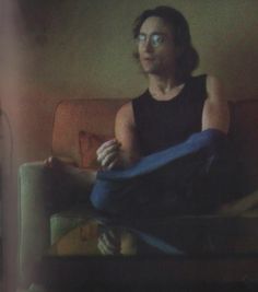 a man with glasses sitting on a couch