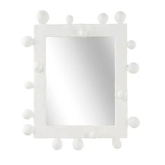 a square mirror with white balls around it