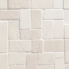 a close up view of a white brick wall