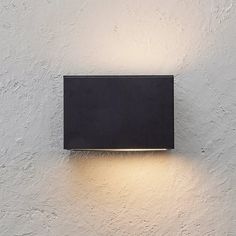 a black light mounted on the side of a white wall