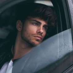 a man in a car looking out the window