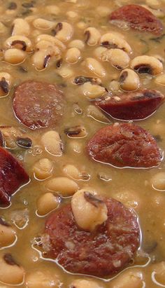 a white bowl filled with beans and sausage