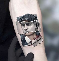 a man's arm with a piece of torn up paper on it and the image of a person wearing a hat