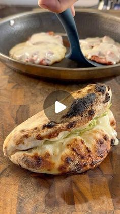 someone is using a spatula to cut up some food in half on a pan